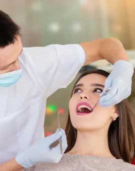 dentist-is-treating-teeth-with-beautiful-girl 1